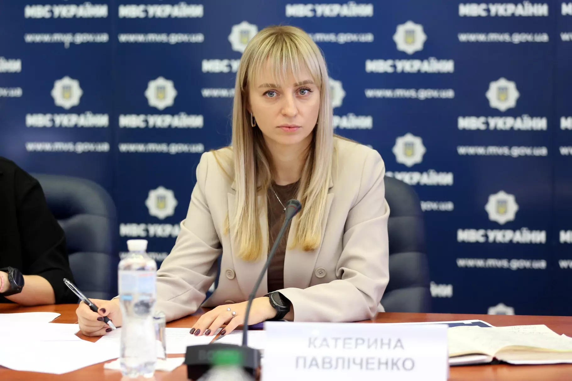 заступниця міністра мвс катерина павліченко: офіцери соб проходять підготовку з психології, інклюзії, комунікації та домедичної допомоги Катерина Павліченко за столом у переговорній залі на фоні банеру МВС