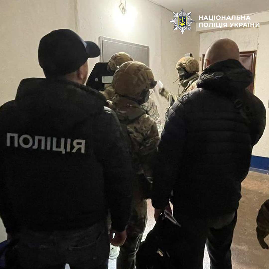 Поліцейські знаходяться у під'їзді будинку біля дверей квартири