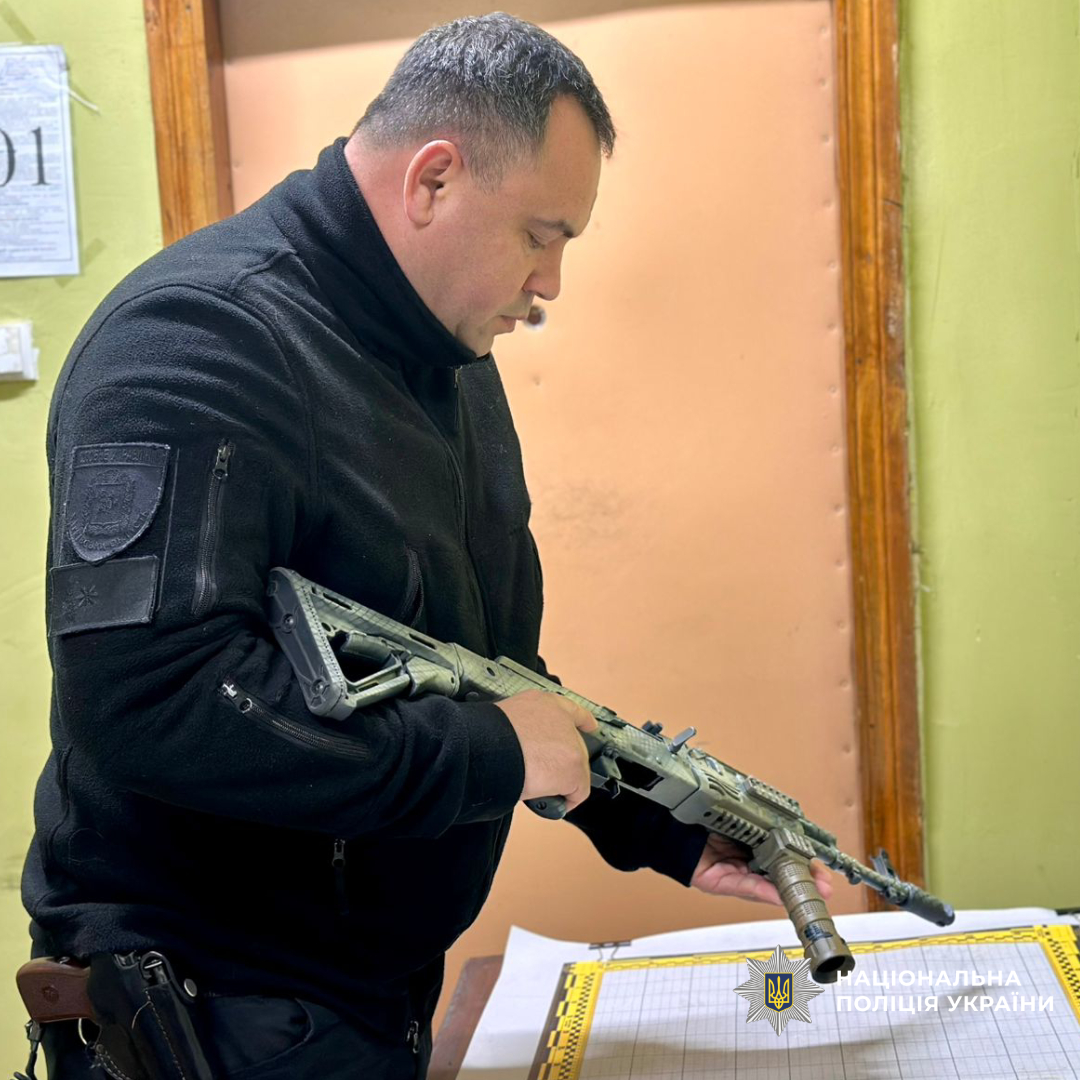Поліцейський оглядає зброю
