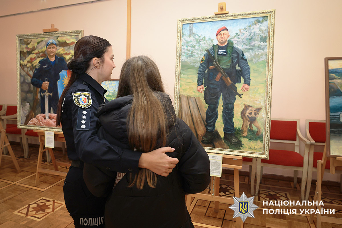 Дитина загиблого захисника біля портрета батька
