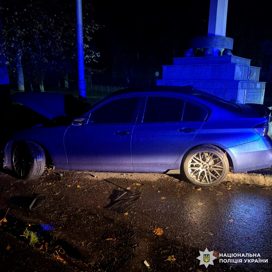 Синій автомобіль врізався у кам’яний постамент, передня частина пошкоджена, аварія сталась уночі.