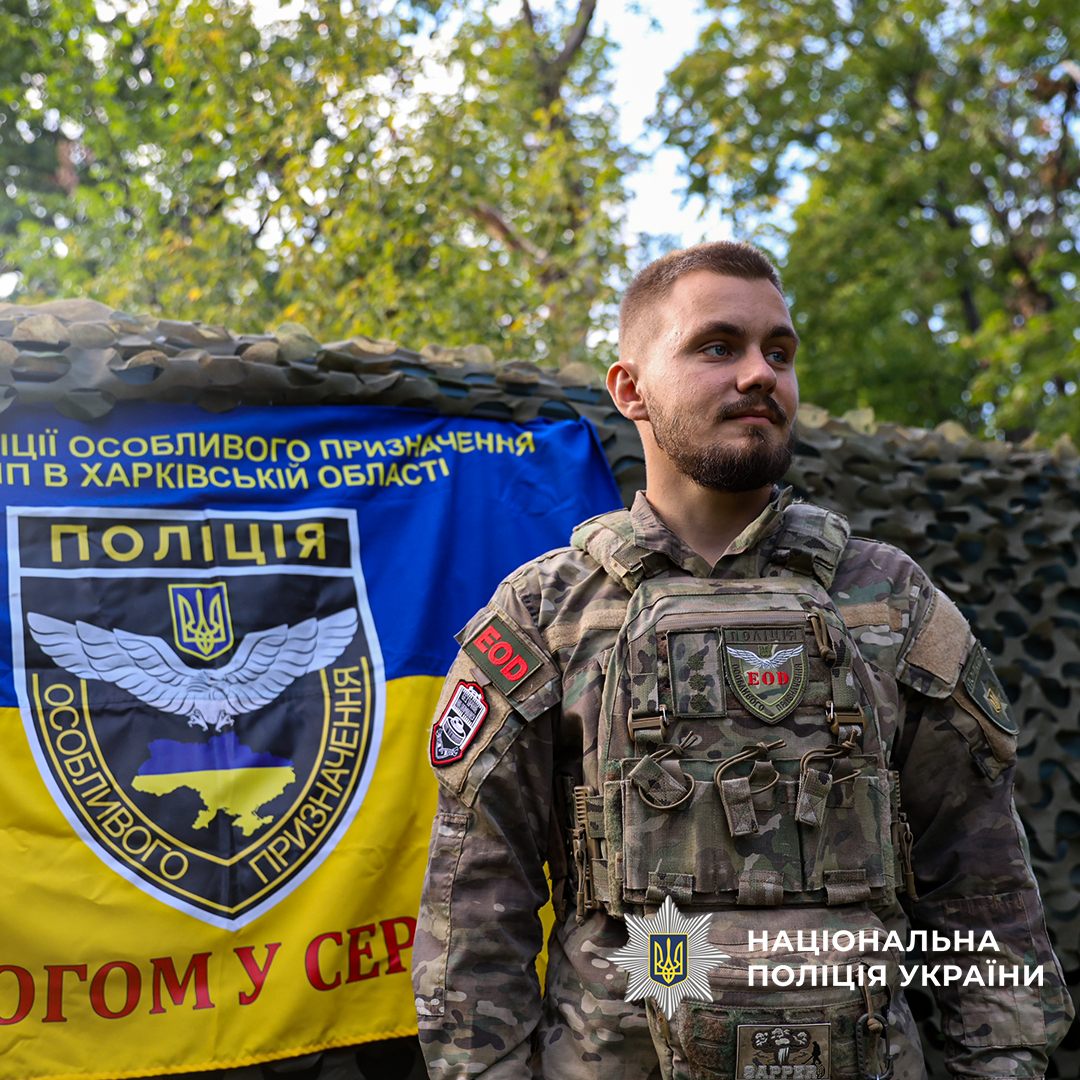 Медж на фоні стяга полку поліції