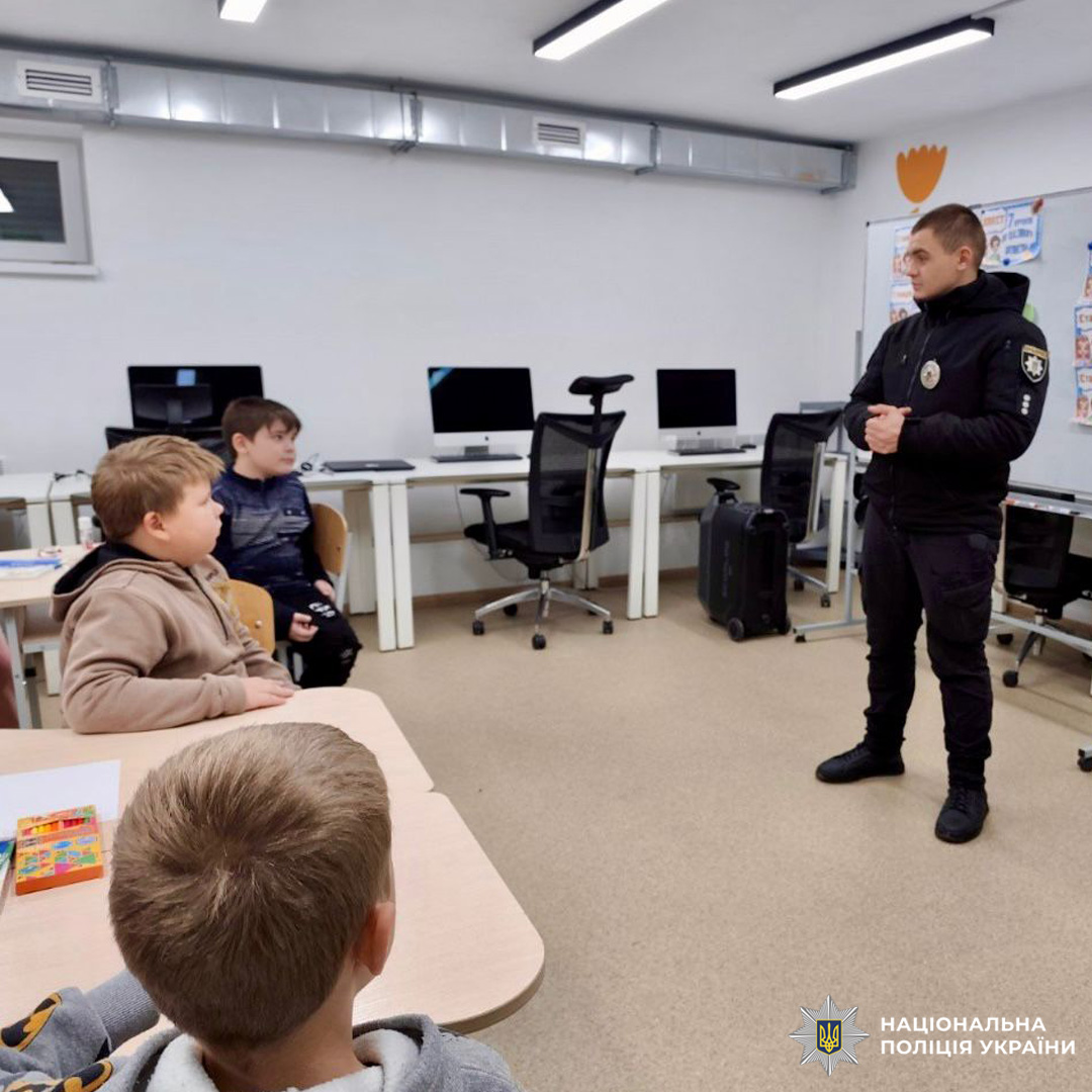Поліцейський спілкується з дітьми в класі. Освітній захід про безпеку та правосвідомість.