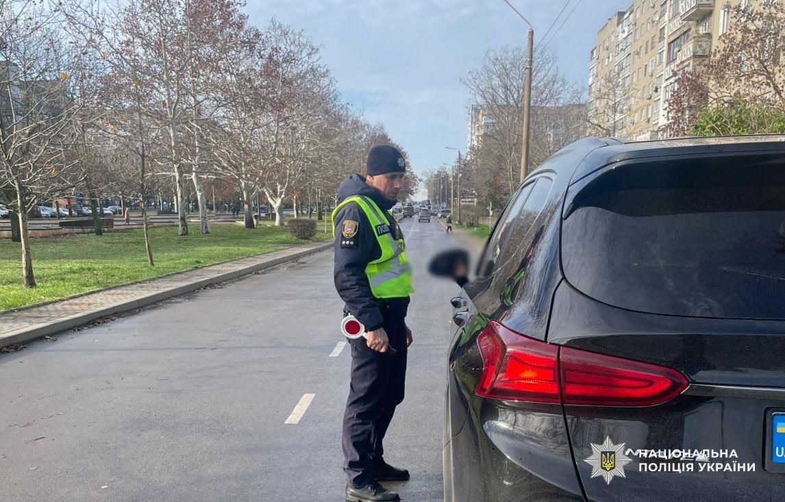 Поліцейський наголошує водію на дотриманні ПДР