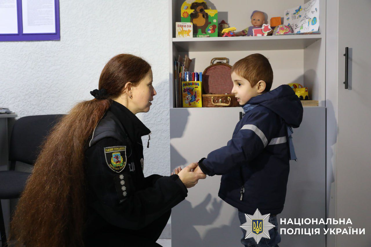 На фото зображено хлопчика разом з полыцейськими.