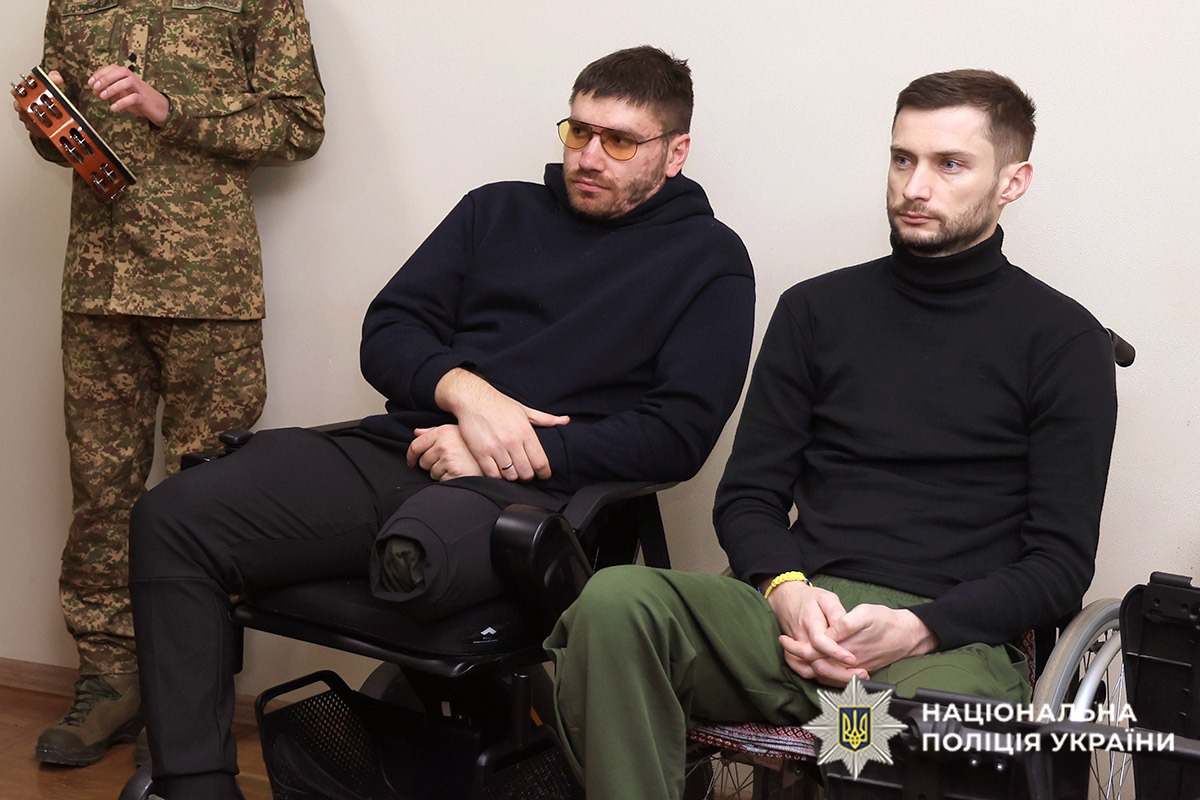 Поранені бійці слухають виступ музикантів