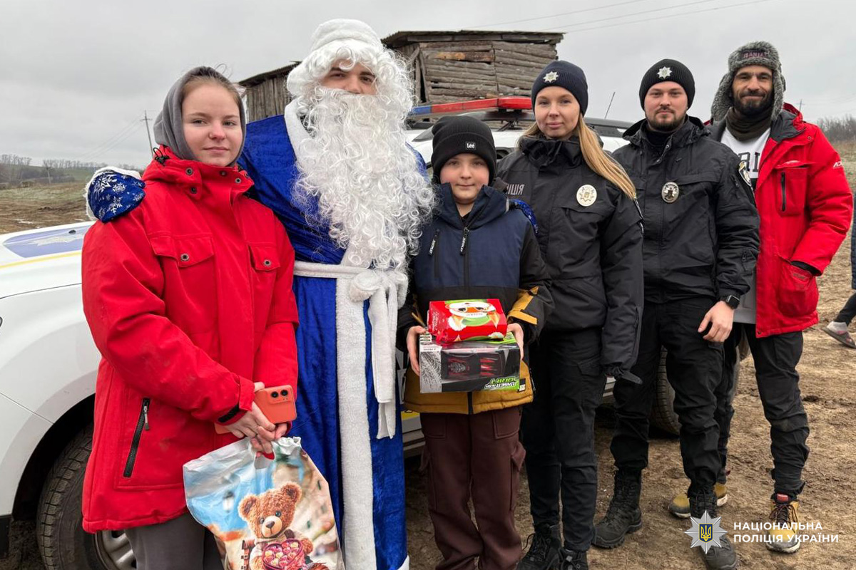 Діти з подарунками поруч із поліцейськими та Дідом Морозом.