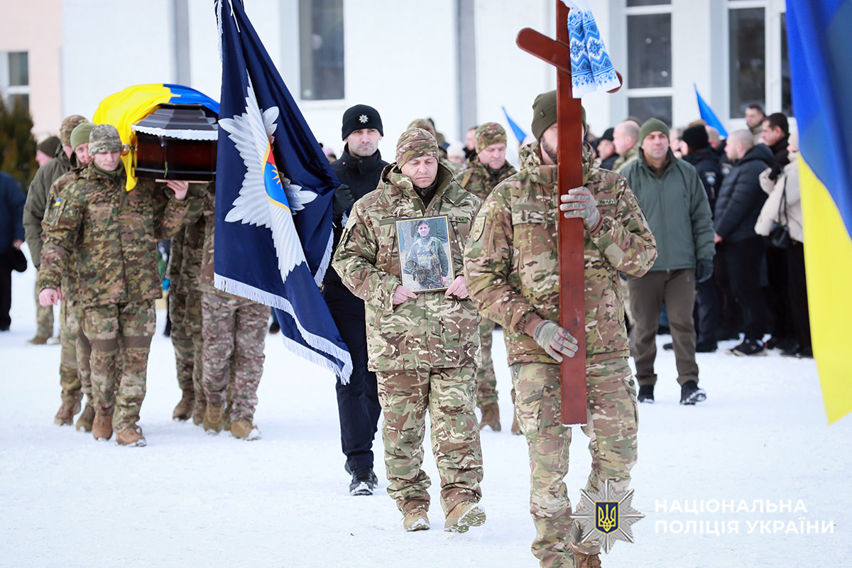 Побратими загиблого несуть хрест, портрет бійця та прапор
