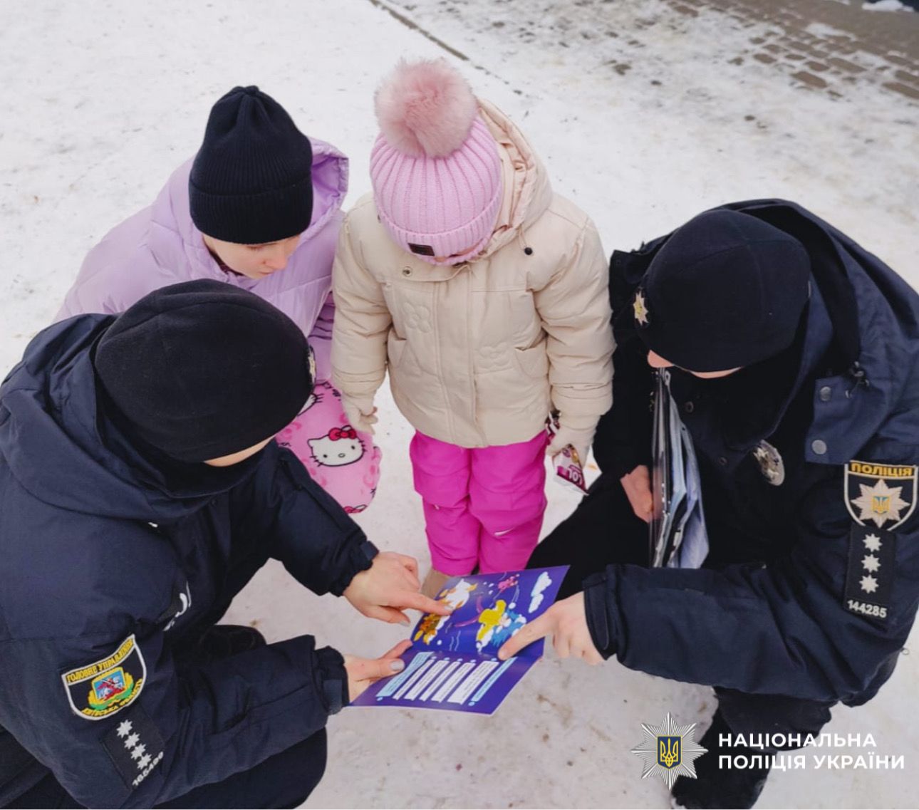 на фото зображені працівники поліції з дітьми