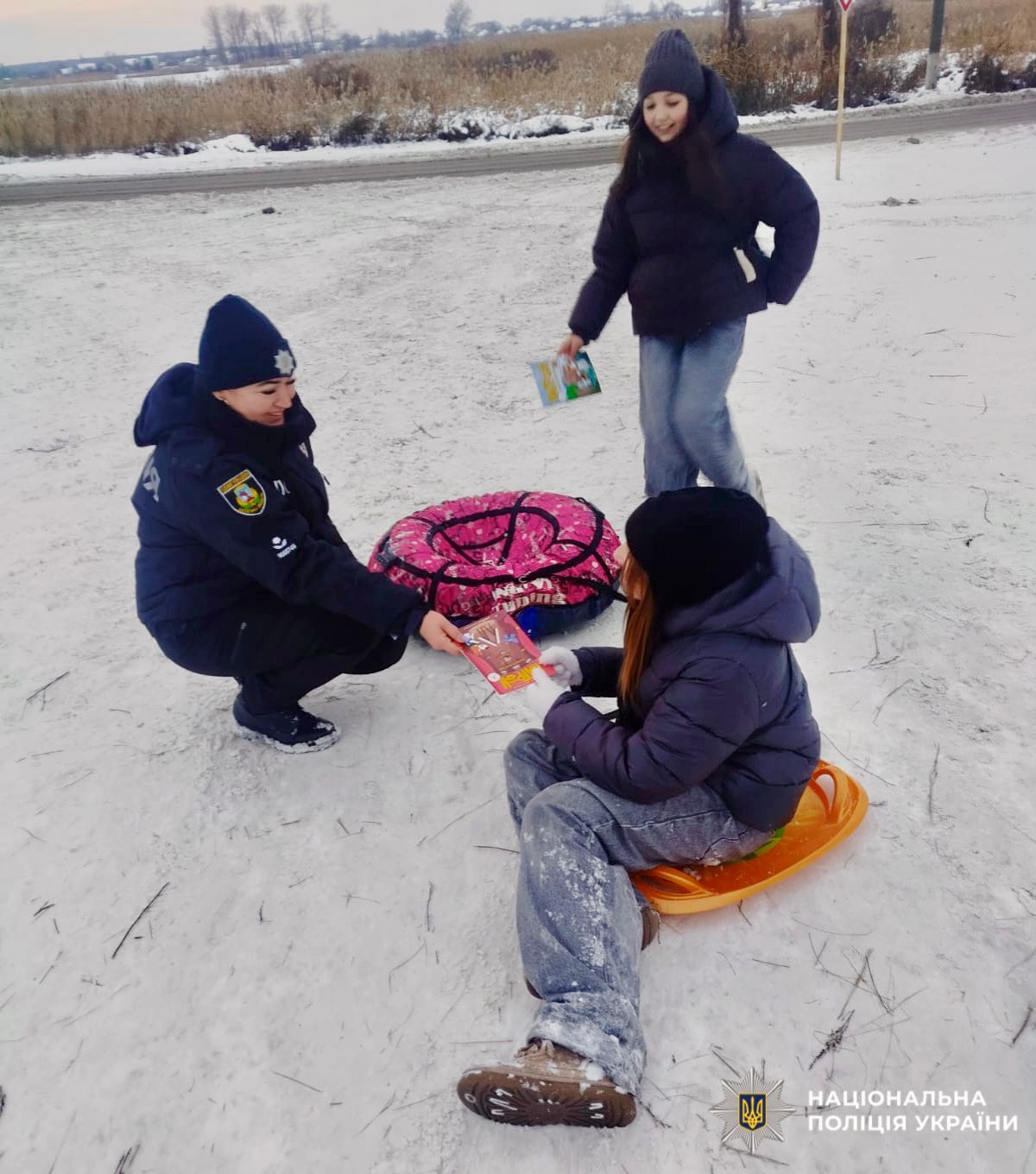 На фото зображена поліцейська та діти під час проведення профілактичних заходів.