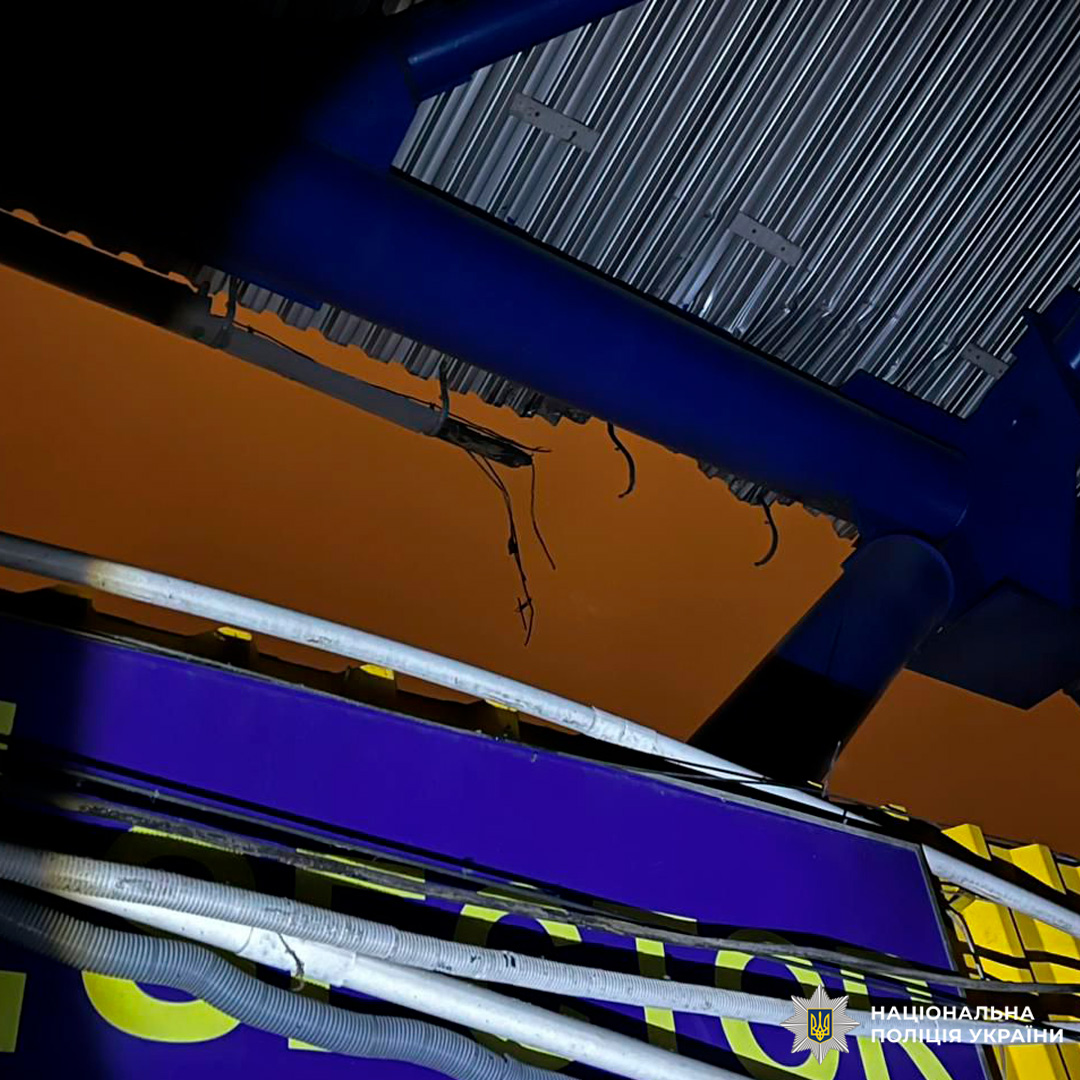 Пошкоджена металева конструкція з оголеними електричними дротами.