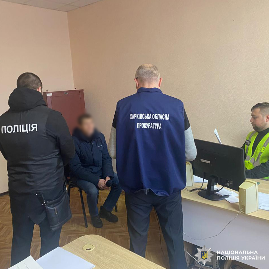 У кабінеті за столом сидить громадянин, поруч поліцейський і представник прокуратури.