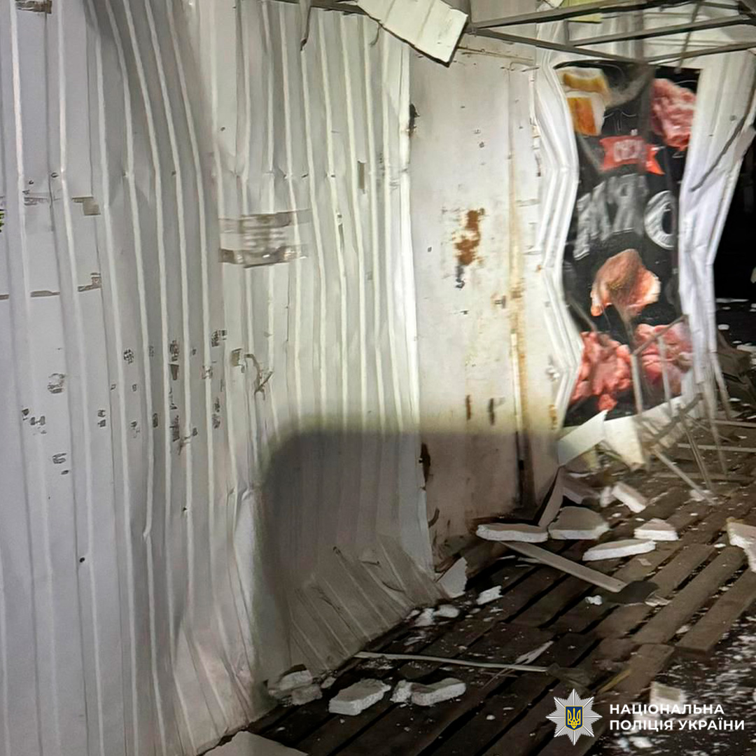 Пошкоджена внутрішня стіна з металевих панелей, уламки та ізоляційні матеріали на підлозі.