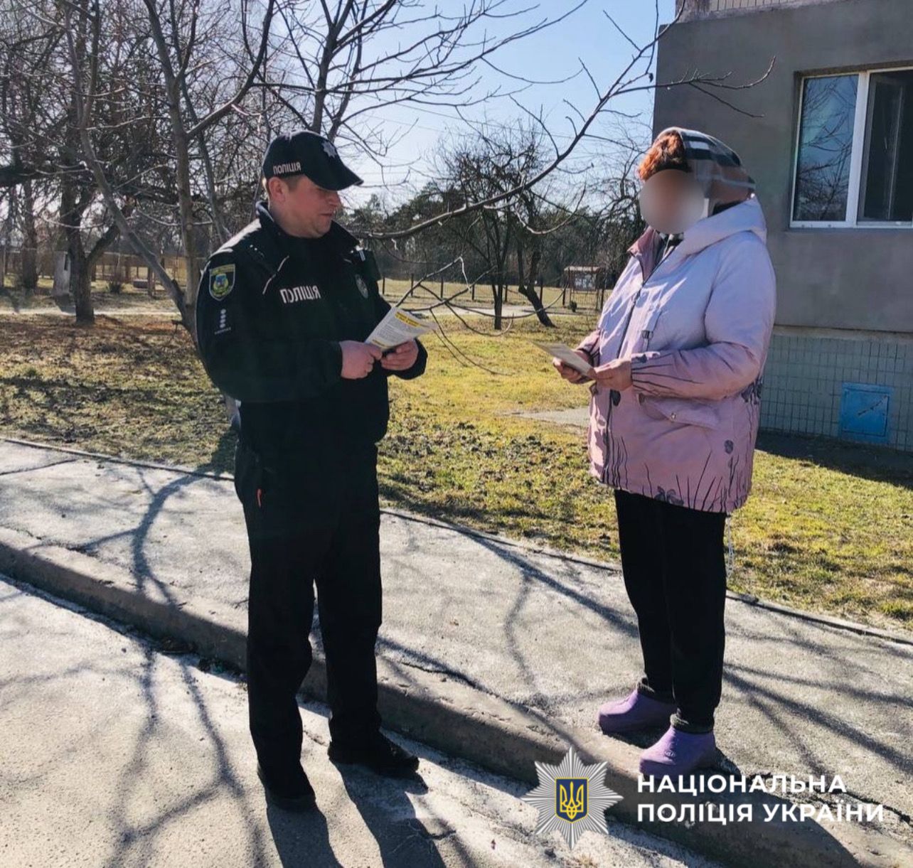 На фотографії зображено поліцейських офіцерів громад, які проводять профілактичні заходи з жителями Бориспільщини.