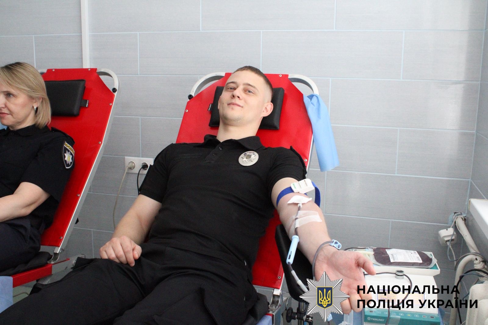 На фото зображений поліцейський, який здає кров для людей