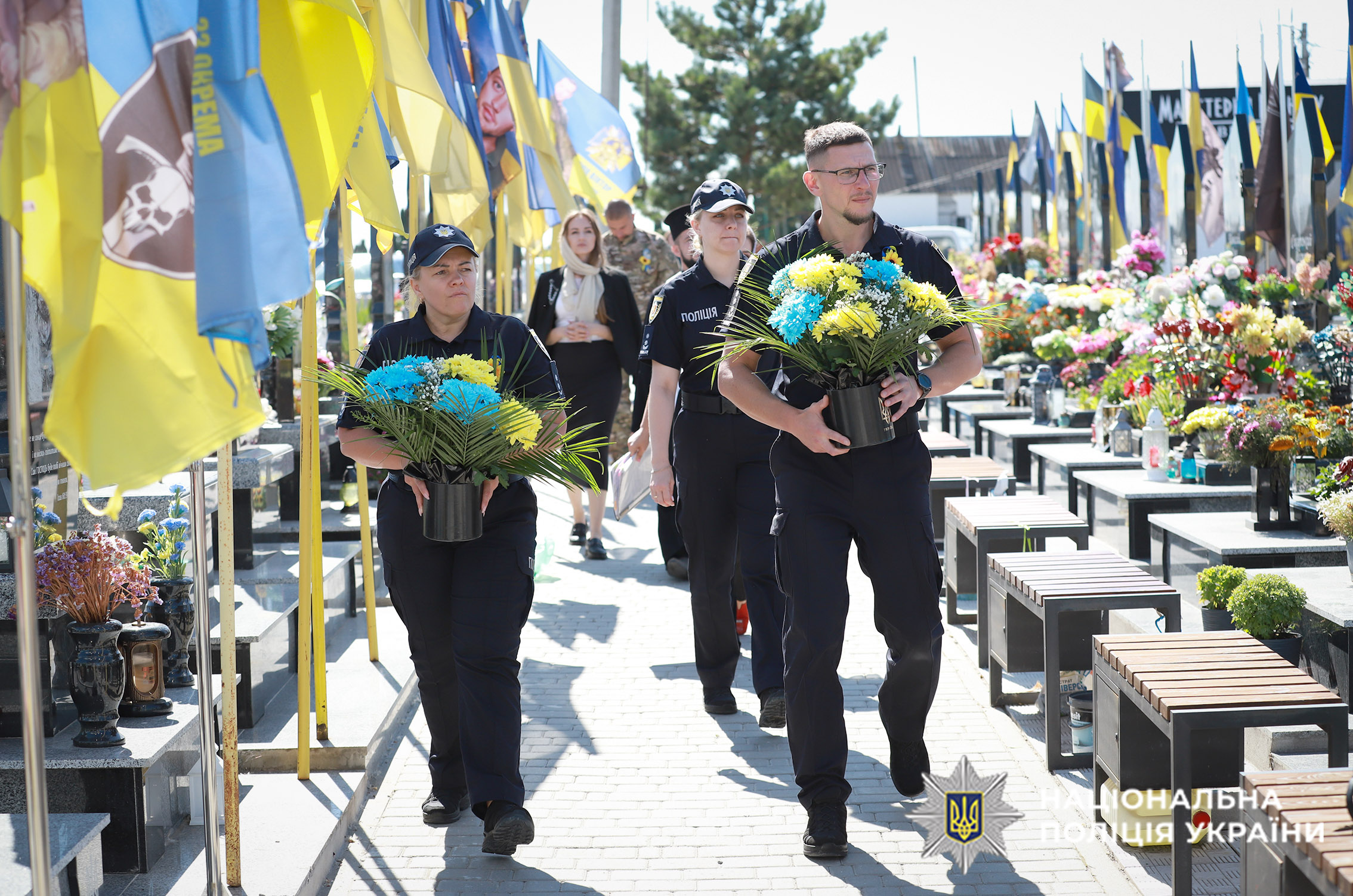 Поліцейські несуть квіти до могил полеглих колег