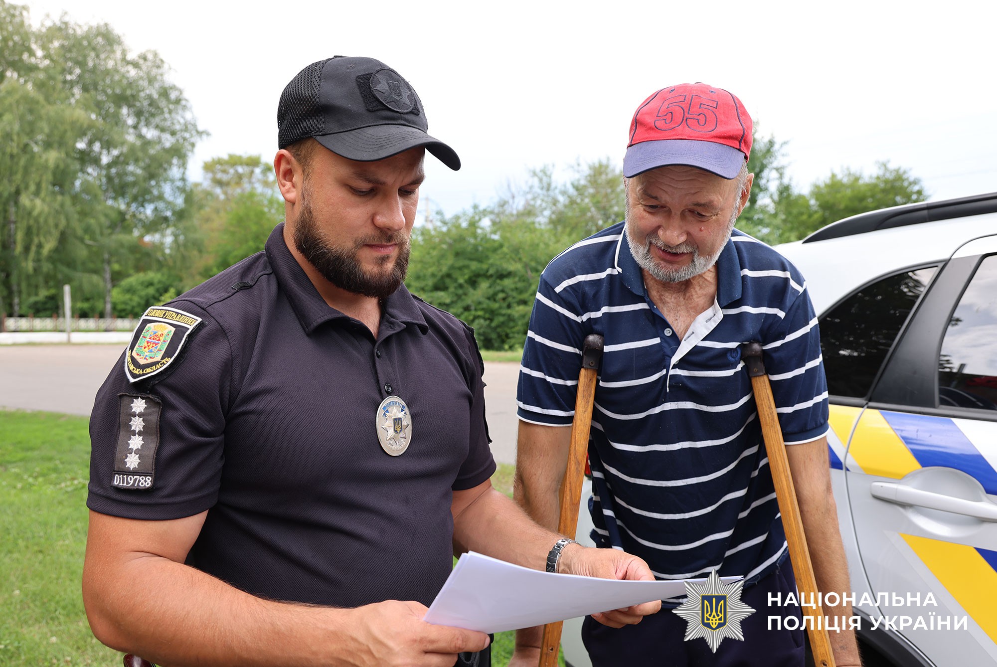 поліцейський спілкується з місцевою мешканкцем про види шахрайства