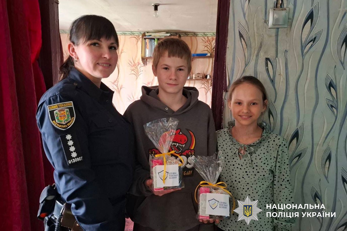 Поліцейська вручає дитині пасочку