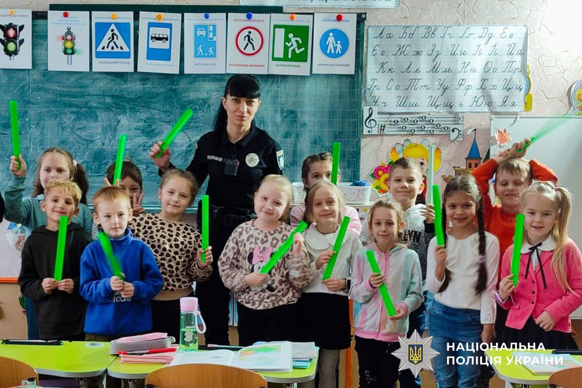 Поліцейська розповідає дітям про світловідбивачі 