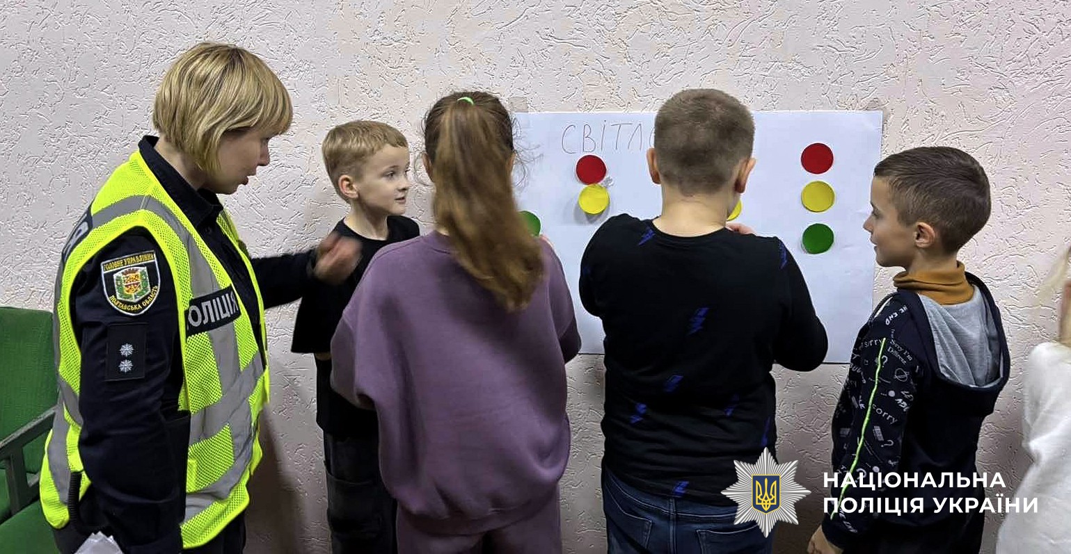 Поліцейська із учнями розбирають тематичні завдання