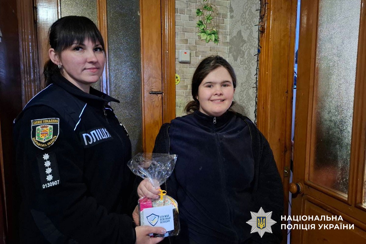 Поліцейська вручає дитині пасочку