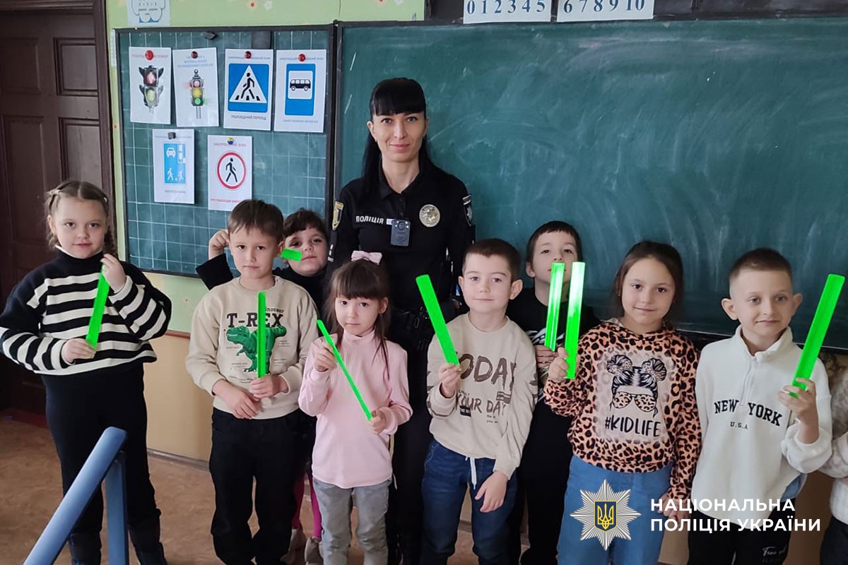 Поліцейська розповідає дітям про світловідбивачі 