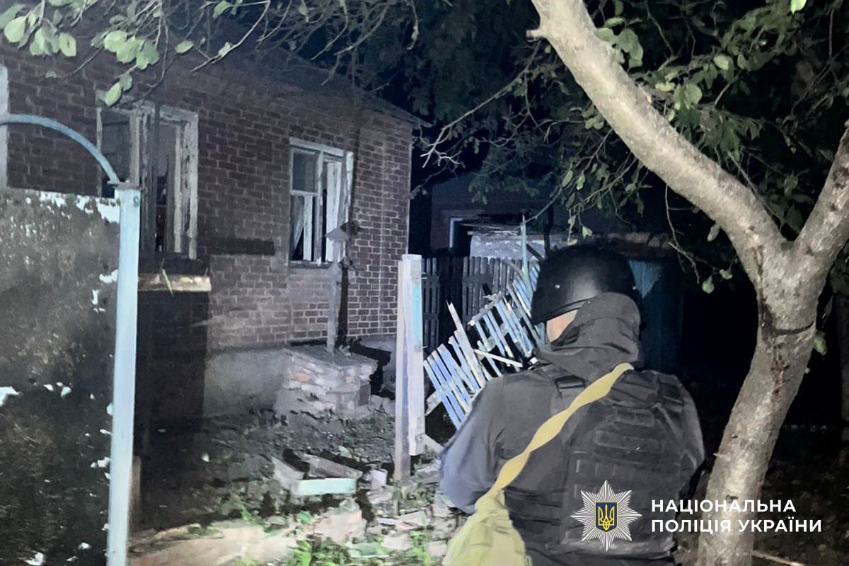 Поліцейський фіксую пошкодження будинку