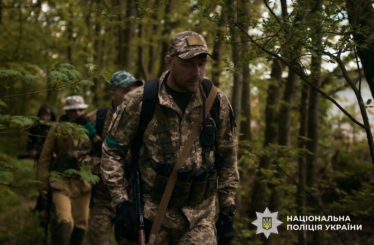 Олександр Сидоржевський у військовій формі разом із побратимами пересувається ділянкою, схожою на ліс